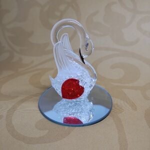 Elegant Spun Glass Swan Figurine with Red Heart Accent On Mirrored Surface